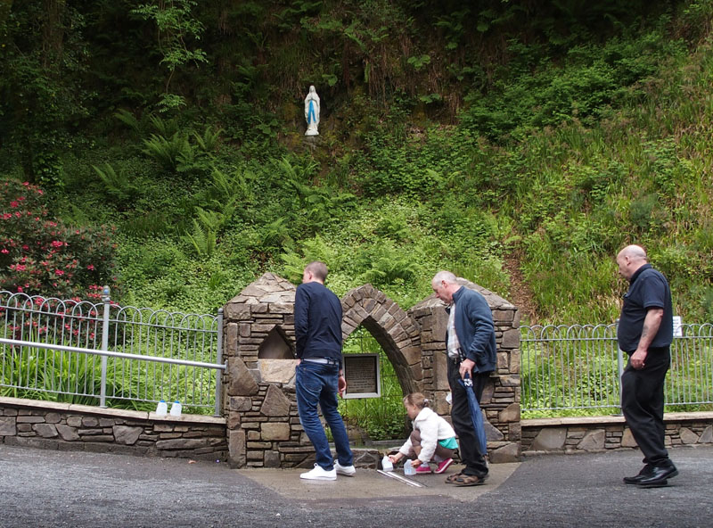 The grotto at Mount Melleray with the statue of Our Lady of Lourdes set in the cliff face above a mountain stream